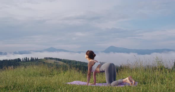 Active Woman Doing Yoga Exercises on Fresh Air alt