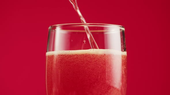 Pouring Foamy Cherry Beer in Glass Closeup Belgian Lambic alt