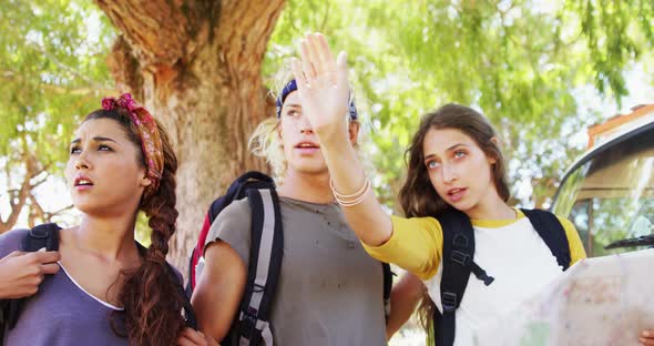 Friends looking at map and pointing at distance 4k alt