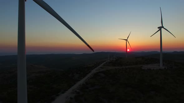 Flying over windmills at dusk alt