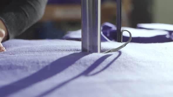 Cutting Fabric on the Table with an Electric Cutter Sewing Production of Clothing alt