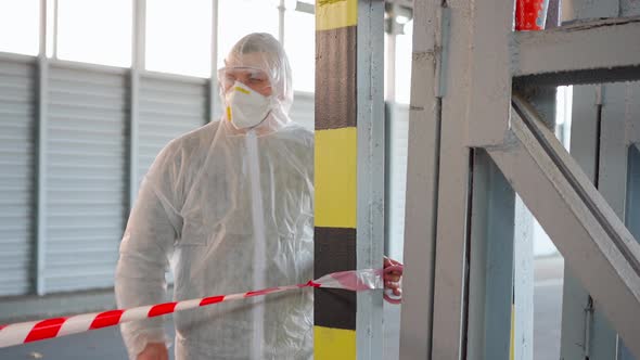 Man Epidemiologist Unwind Signal Red White Tape Enclose Restricted Area Coronavirus Pandemic