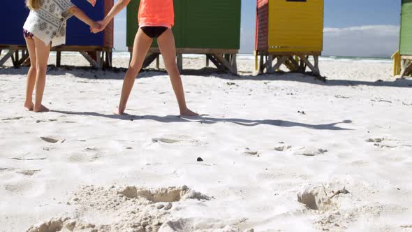 Siblings standing together in the beach 4k alt