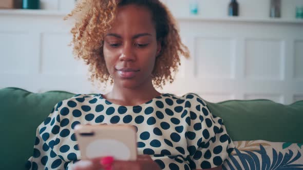 African American Woman Uses Mobile Phone to Communicate Online and Browse Web alt