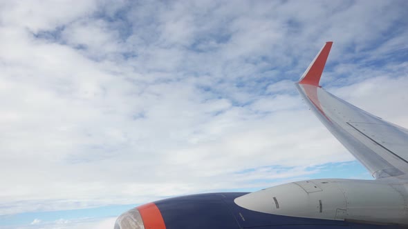 View of the Wing and Turbine of an Airplane That Turns, Visually It Seems As If the Plane Is Falling