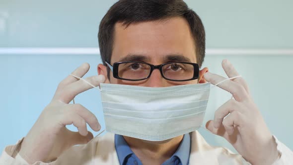 The Medical Worker Puts on a Mask alt