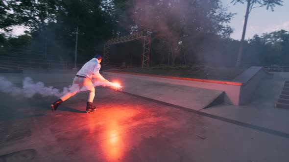 Aggressive Inline Roller Skater Doing Tricks in Concrete Skatepark with Red Burning Signal Flare alt