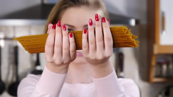 Girl Shows Long Spaghetti Pasta