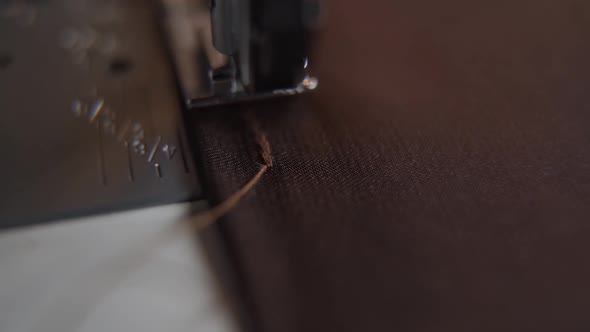 Sewing machine stitching thick thread on fabric macro