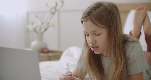Face of Schoolgirl Learning Online, Thinking and Answering on Questions From Home, Using Video Chat