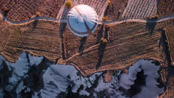 A Balloon is Flying Over Limestone Rock Precipice Filmed From Above By Drone alt