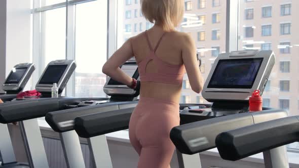 Young woman training on treadmill