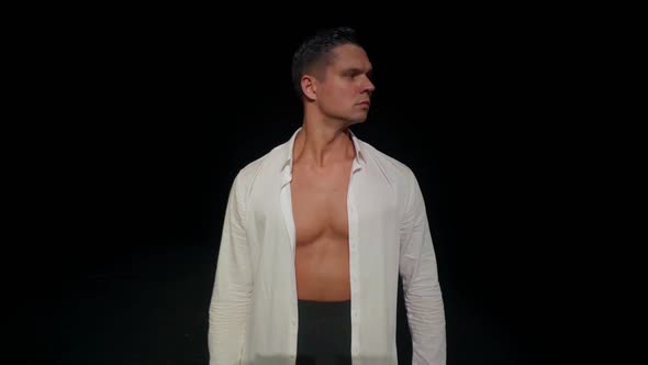 Young Man with Bare Breastsstrong Pectoral Muscles and Absopen White Shirtblack Dance Trousers on