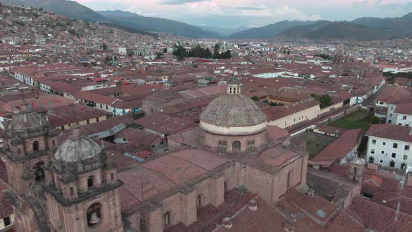 4k daytime aerial drone footage over the Church of the Society of Jesus from Plaza de Armas in Cusco alt