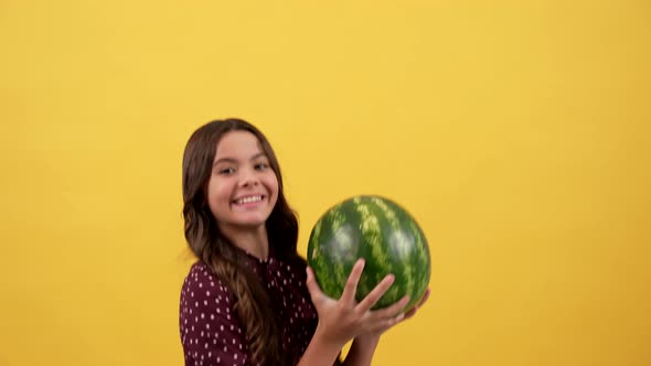 Cheerful Child Hold Water Melon with Success Gesture on Yellow Background Vitamin alt