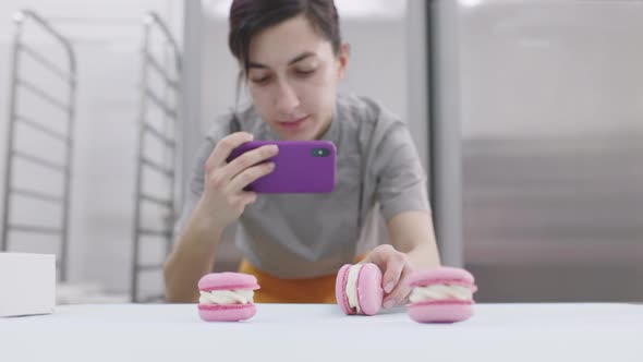 Young Girl Takes Pictures of Bright Macaroons