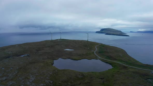 Aerial View of Wind Turbines on a Cape in Dramatic Weather alt
