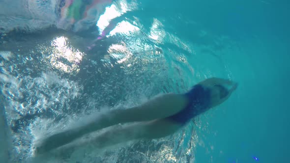 Female Swimmer Practicing Flip Turn alt