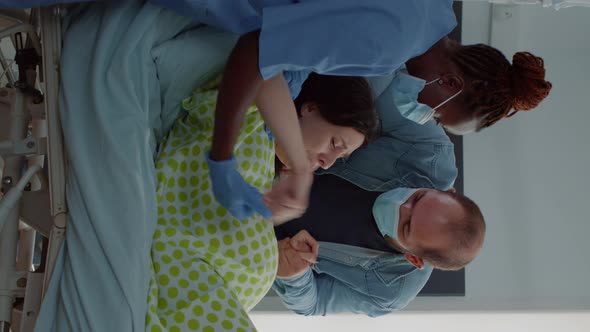 Vertical Video Obstetrics Doctor and African American Nurse Assisting Birth alt