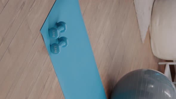 Vertical Video Nobody in Living Room with Sport Equipment on Floor alt