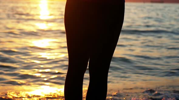 Woman performing yoga on the beach alt