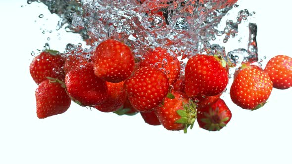Super Slow Motion Shot of Falling Strawberries Into Water at 1000Fps alt