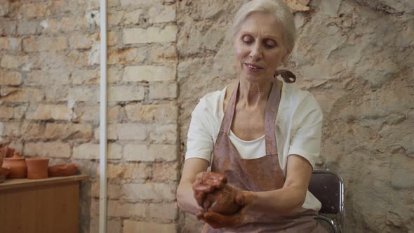 Senior Woman Works with Clay alt