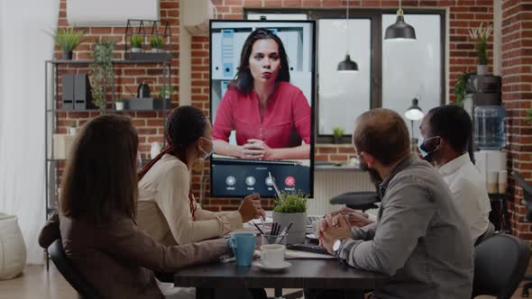 Colleagues Meeting with Woman on Video Call Conference alt