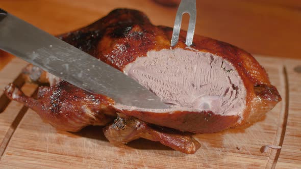 Crispy Skinned Roast Young Duck Is Slicing Along Breast With Sharp Knife