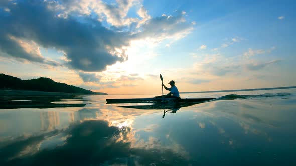 River Surface Is Getting Rippled By the Sailing Oarsman alt