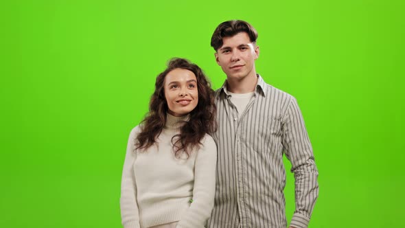 A Man and a Woman are Standing and Looking at the Camera alt