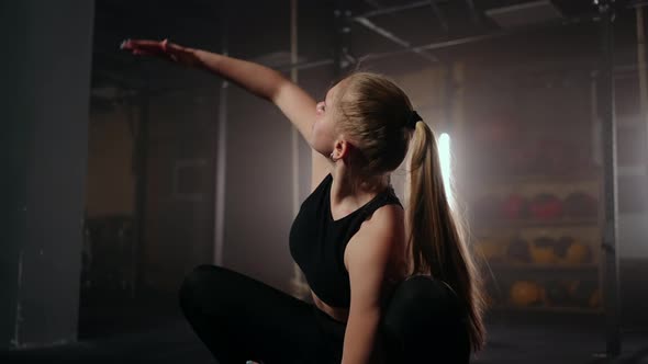 A Young Slender Woman Prepares and Warms Up Before Training alt