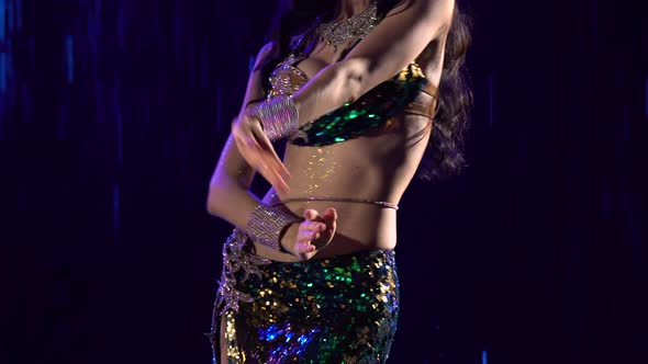 Young Woman in an Exotic Green Suit Performs Belly Dance Moves Hips and Wriggle Half Naked Body alt