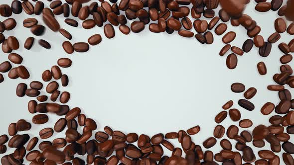 Coffee Beans Falling Down Forming Elliptical Space For Logo Or Sign