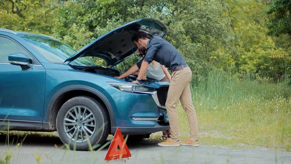 Car Trouble.Car Accident.Car Engine Overheating Engine.Businessman Waiting Car Repair Service alt