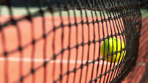 Super Slow Motion Shot of Tennis Ball Hitting the Net on Court at 1000Fps alt