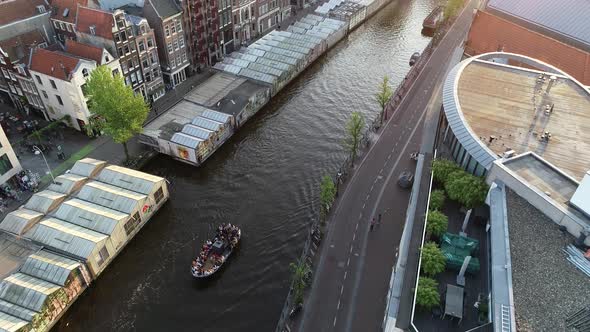 Aerial view of famous canal in Amsterdam, Netherlands, Party boat and typical dutch houses