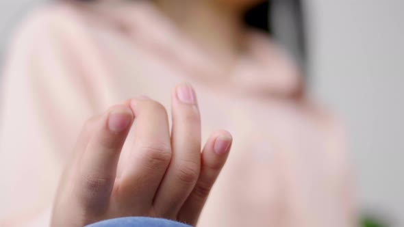 Close up hand of Asian woman doing meditation and sitting in lotus pose on couch alt