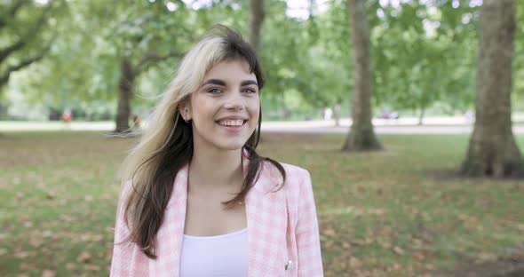 Portrait of smiling woman in public park
