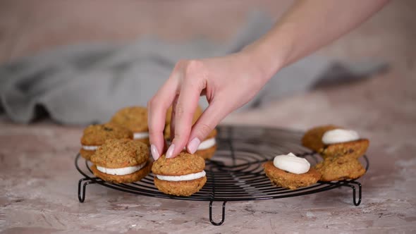 Confectioner Making Sandwich Cookies with Cream Cheese Filling