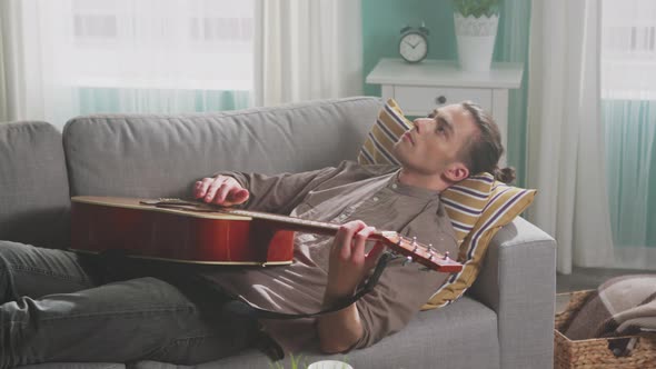 Young Man Is Relaxing On Sofa alt