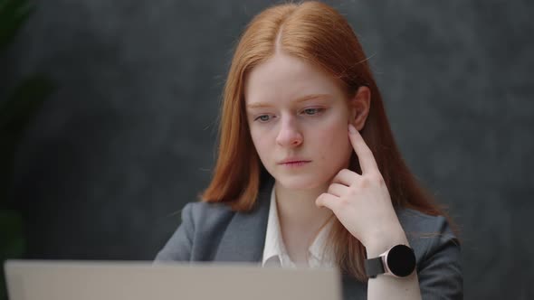 Young Intern Lawyer Woman is Reading Agreement and Report in Laptop Portrait of Pretty Serious Lady alt