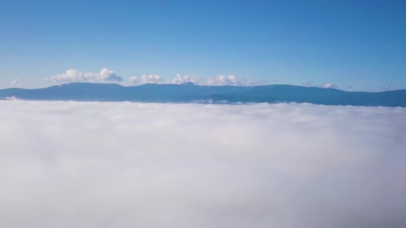 Flying above clouds in high mountains