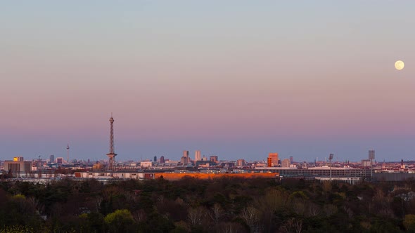 Day to Night Time Lapse of Berlin cityscape with full moon rising, Berlin, Germany
