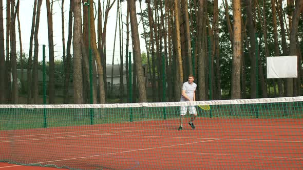 Tennis Player Hitting Volley Shot During Game alt