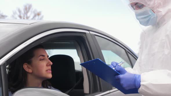 Healthcare Worker with Clipboard and Woman in Car alt