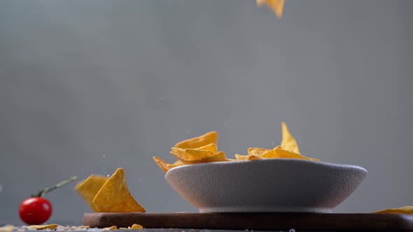 Tortillas Chips Falling Down in White Bowl