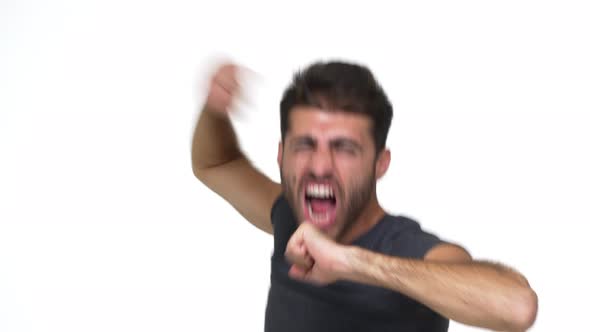 Cheerful Smiling Guy in Grey Tshirt Dancing Wildly Full of Energy Making Uncontrolled Movements alt