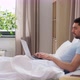 Man with Laptop in Bed at Home Bedroom - VideoHive Item for Sale