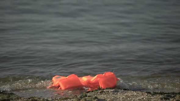 Life Jacket Floating on Sea Water Near Shore, Search for Victims After Disaster alt